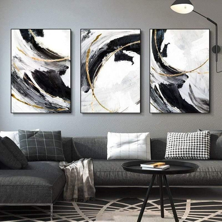 Set of 3 modern abstract wall art canvas prints by 5th Color featuring black, white, and gold minimalist luxury home decor.