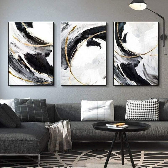 Set of 3 modern abstract wall art canvas prints by 5th Color featuring black, white, and gold minimalist luxury home decor.
